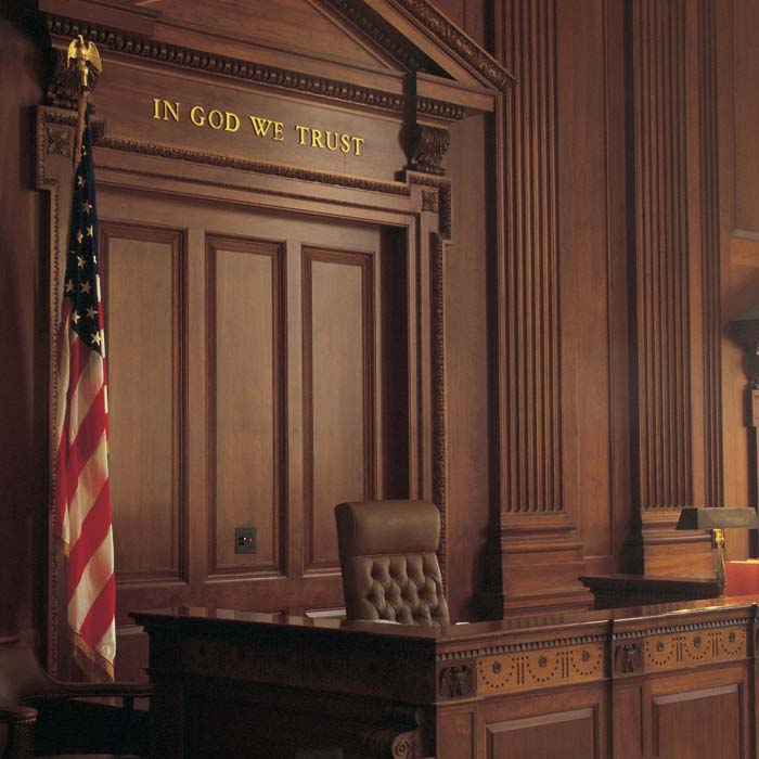 Court room with dark wood fixtures and American flag