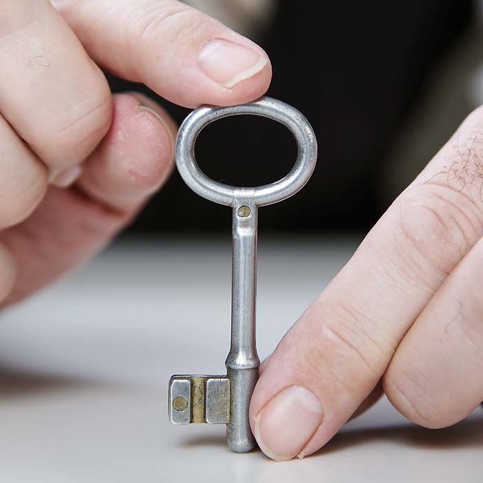 Person holding silver key