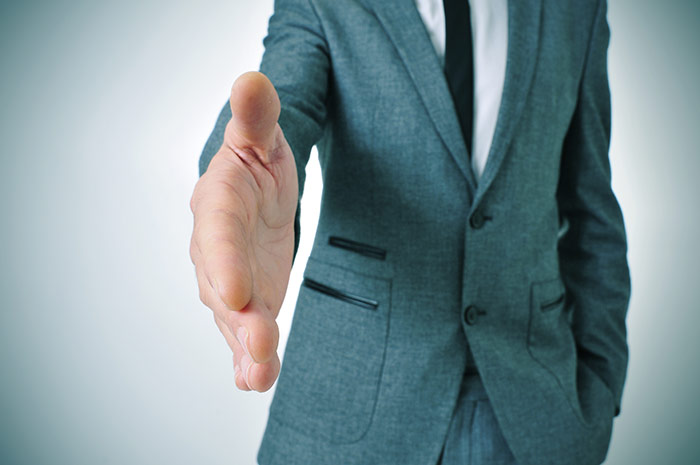 Man reaching out hand to shake hands