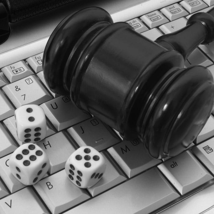 Online gambling and law theme with gavel and dice on keyboard