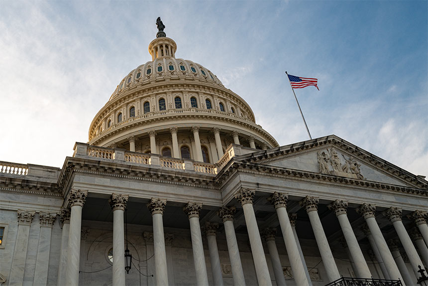 US Capitol Building against blue sky with clouds